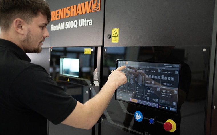 Machine operator using the touchscreen on a Renishaw RenAM 500Q Ultra printer