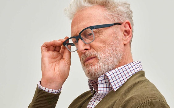 Older man wearing Morrow autofocal eyewear and holding the side