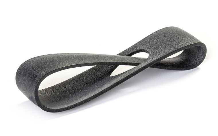 A dark gray 3D-printed loop made from PA 12S using Multi Jet Fusion, with an extra-smooth finish.