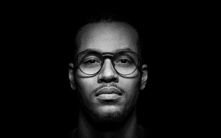 Black and white image of a man modeling fmhofmann eyewear from the cosmos collection
