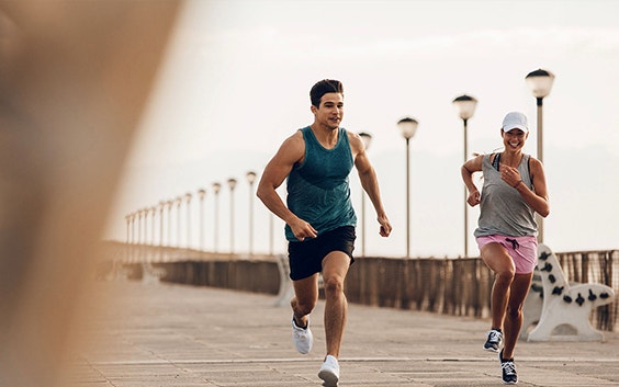 People running on a boardwalk