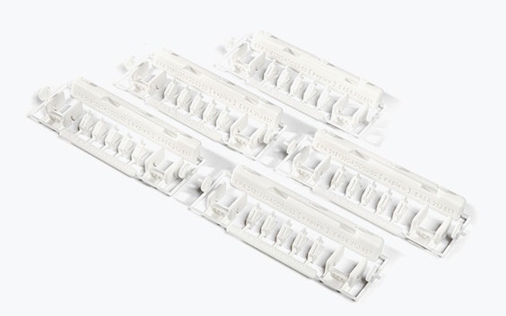 A collection of white 3D printed Expleo repair kits made in PA 2241-FR using SLS.