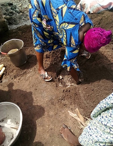 Beninese women planting banana clippings