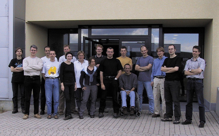 A group photo of Materialise employees standing outside Materialise HQ
