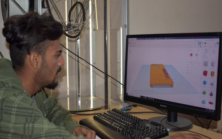 Man creating a 3D printing file on a computer