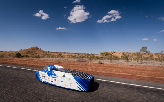 Solar car driving along a road in the Australian outback