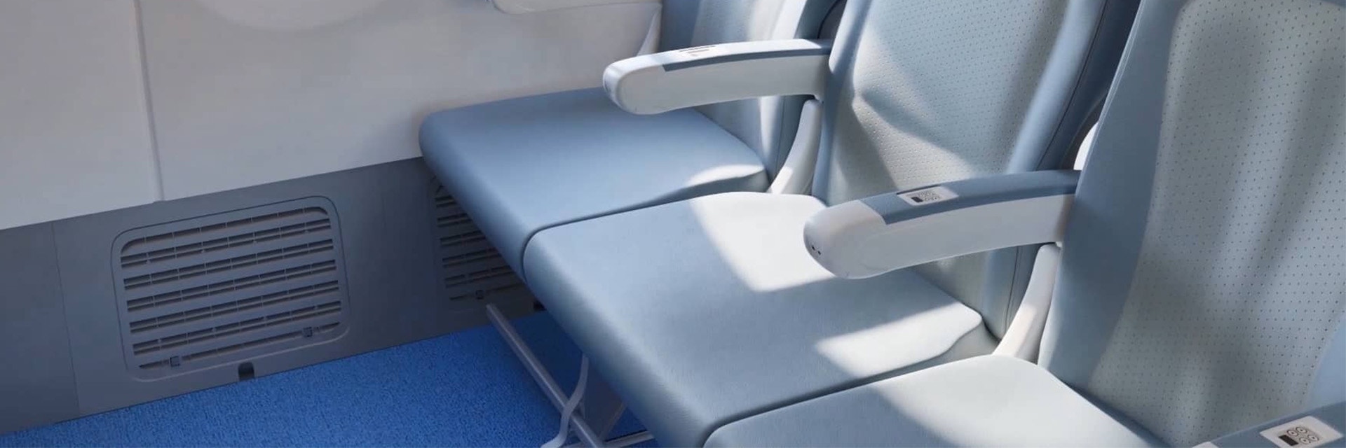 Dreierreihe von Sitzen in einem Flugzeug mit sichtbarem Sockel an der Seitenwand