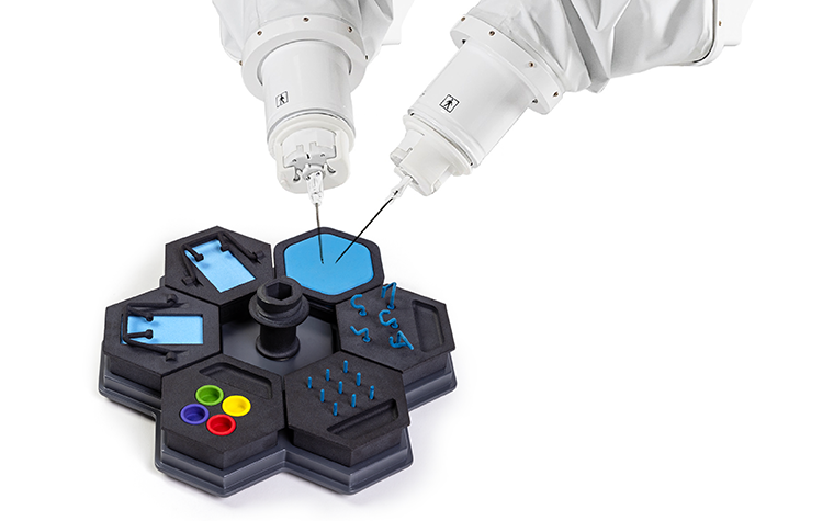 Two robotic microsurgery arms operating on MMI's microsurgery training board.