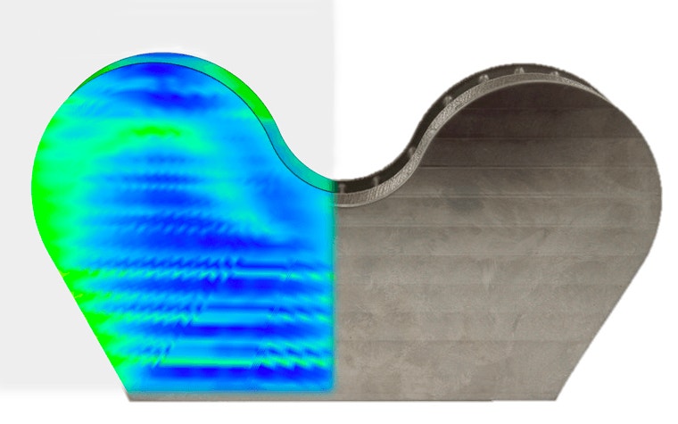 3D-printed titanium insert from Atos with half showing a colored map from the simulation software