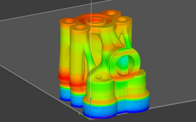 Ansys Simulationモジュールで解析されるサポート付き3Dモデルの熱シグネチャ。そのパーツは5本のチューブから成り、モデルは赤、緑、黄色の組み合わせで、サポートは青色です。