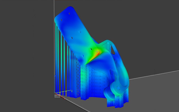 The heat signature of a 3D model with supports being analyzed in the Ansys Simulation module. The middle/flat section of the part is green with a hint of red, while the rest is blue