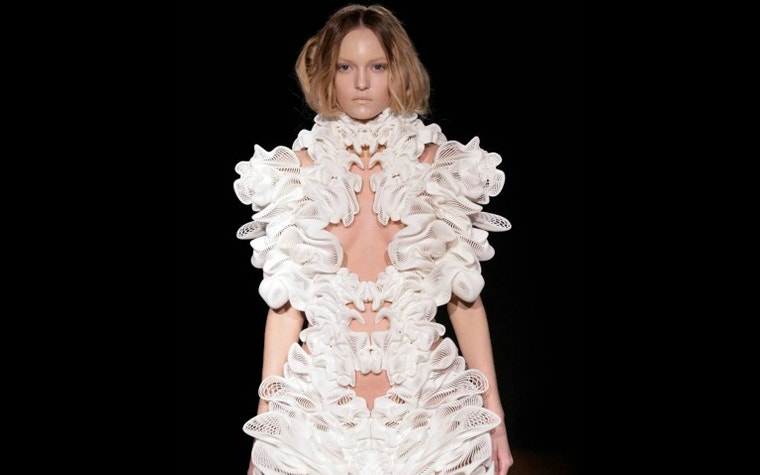 Model wearing a 3D-printed dress on a runway