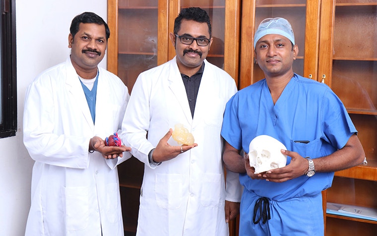 AIMS team holding 3D-printed anatomical models 