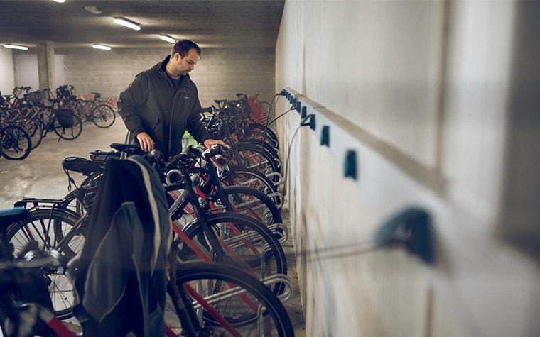 A man in a bike storage area.