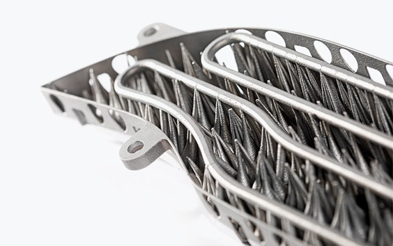 Underside of a 3D-printed metal lamination tool with cooling channels for automotive use