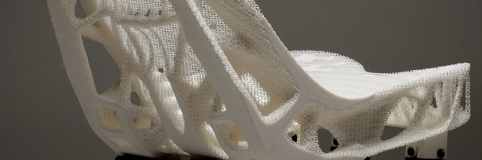 Rear view of a 3D-printed car seat with lightweight structures