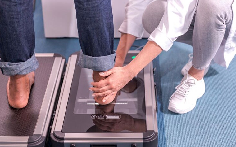 Doctor placing a patient's foot on a scanner