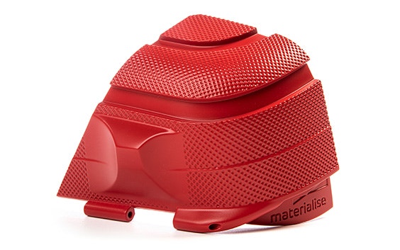 A corner of a textured red Samsonite suitcase. This 3D-printed part demonstrates digital texturing, where textures are applied on the 3D file and directly printed instead of using a post-processing technique. 