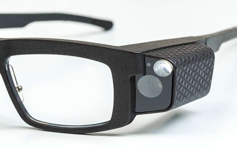 Close-up of the camera and zoom lens on the Iristick Z1 smart glasses, next to the wearer’s left temple