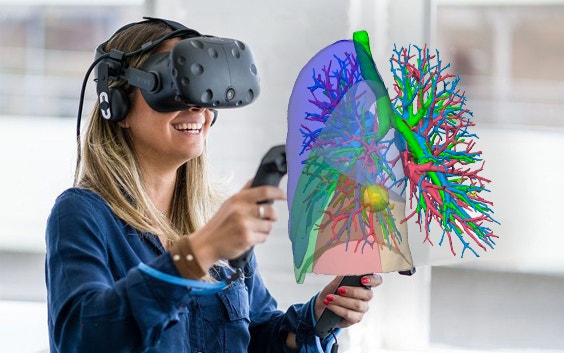 Woman smiling and using a VR headset to check a 3D model of airways