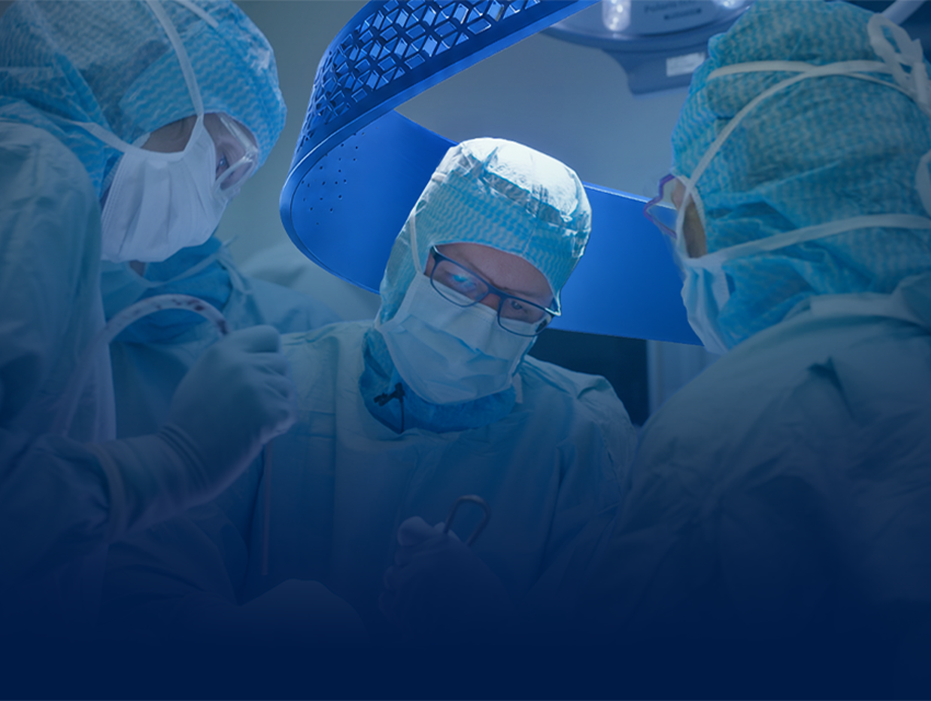 A group of surgeons in a operating room with the Materialise CMF signature blue swirl in the background.