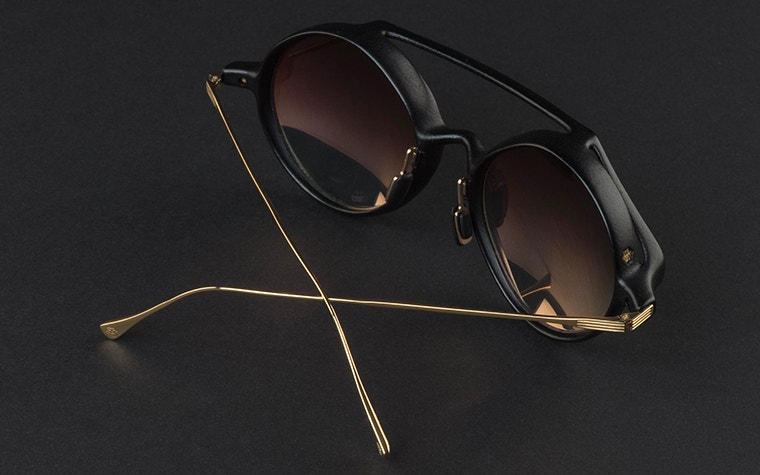 Top view of the IMPRESSIO Vortex sunglasses with the gold bands crossing over each other