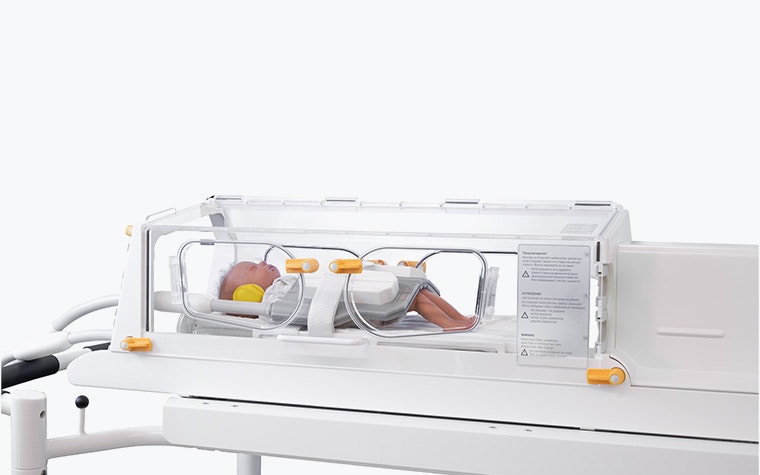 A small baby inside one of LMT's MRI-compatible incubators.