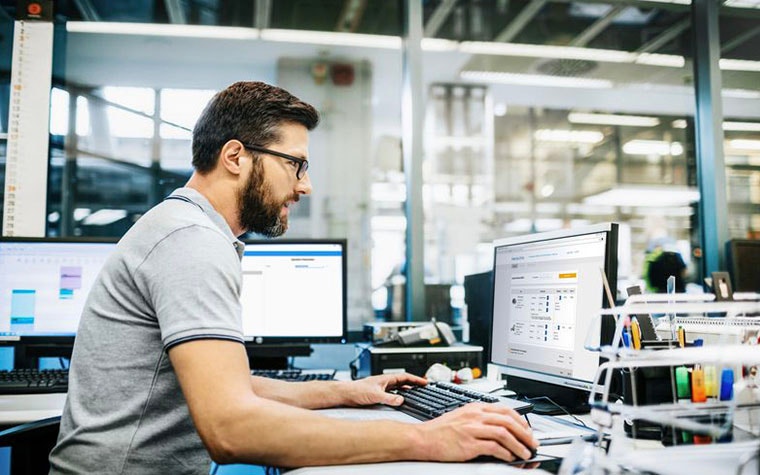 Man sitting at a computer in an office environment