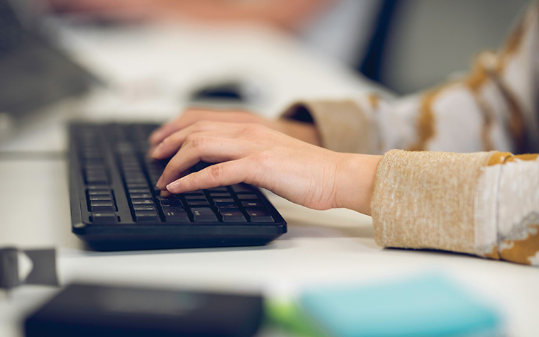 materialise-employee-working-keyboard-desk.png