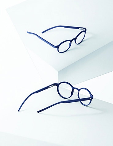 Blue Yuniku+Ørgreen eyeglasses reflected in a mirror