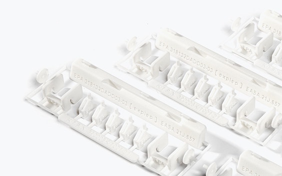 A series of 3D-printed repair kits with EASA 21.J quality labels. The kit contains small white plastic parts made of flame-retardant polyamide, designed by Expleo. These parts are used to replace commonly broken latches on Boeing 737 dado panels. 