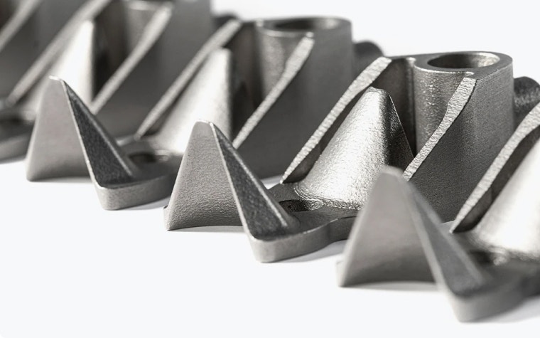 A row of identical metal 3D-printed parts