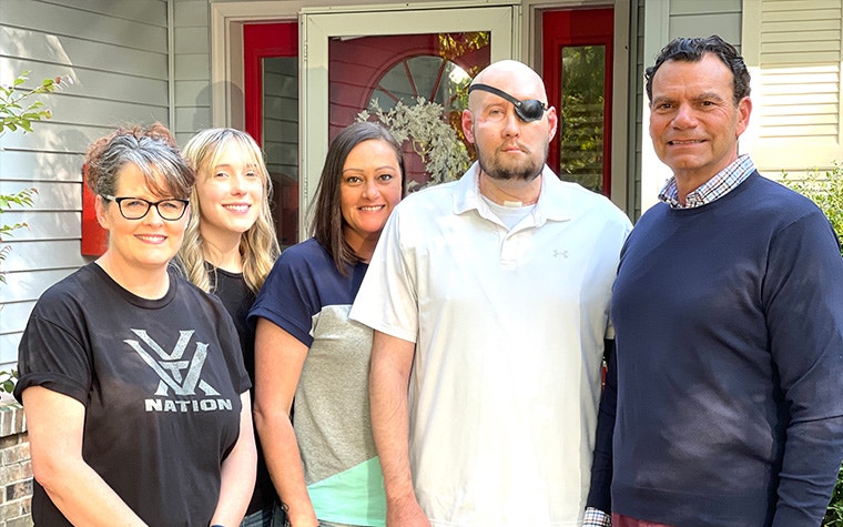 Patient Aaron Jones and his family posing with Eduardo D. Rodriguez, MD, DDS post surgery