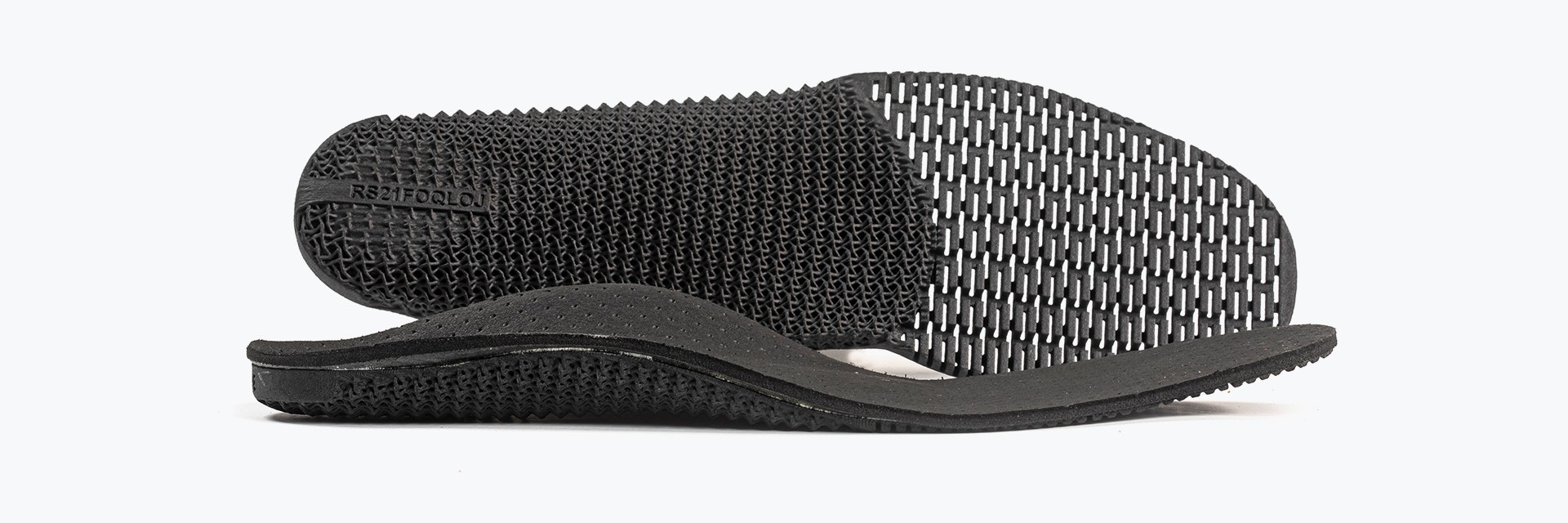 Two 3D-printed phits insoles, one lying flat and the other on its side