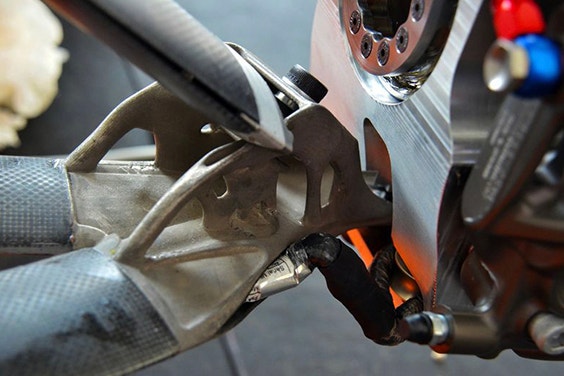 Close-up of 3D printed titanium wishbones on an electric racing car 