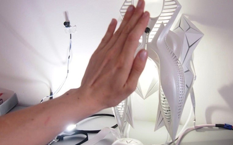 Hand touching the 3D-printed component for a dress design