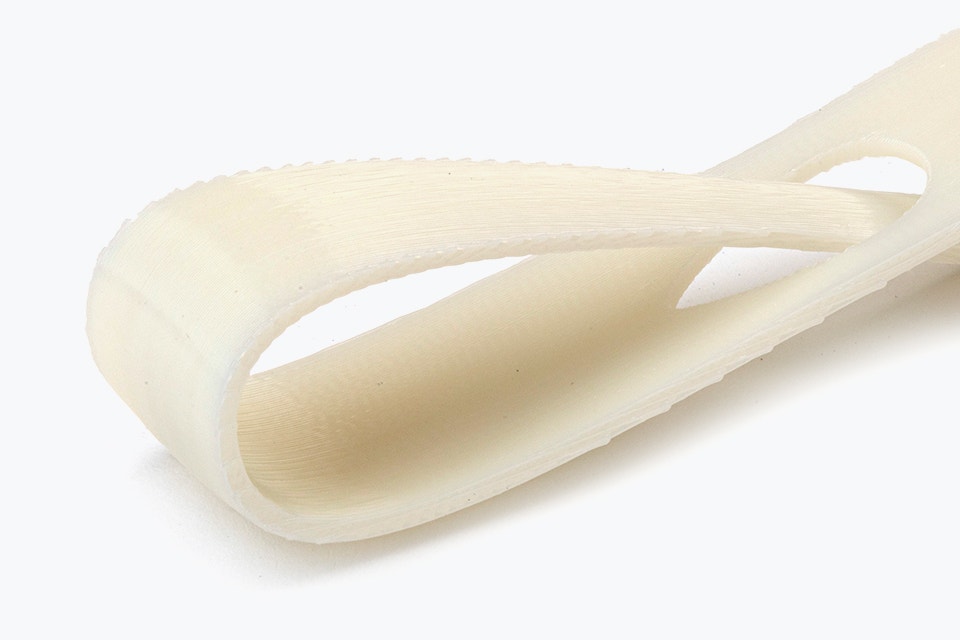 Close-up view of a white 3D-printed loop made from ABS-M30i using fused deposition modeling with a normal finish