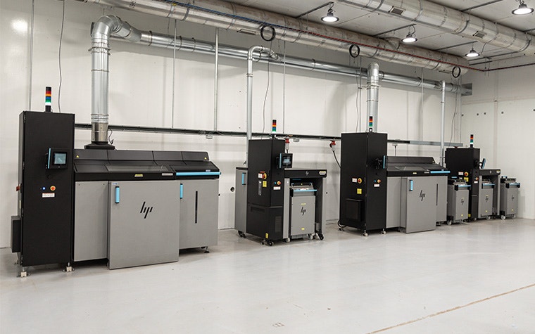 A row of HP 3D printers in Endeavor 3D's printing facilities