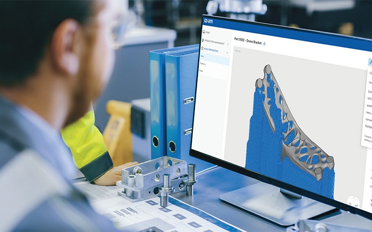 A man looking at a drone bracket design in the CO-AM software platform