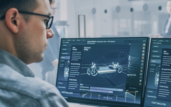 Man looking at automotive designs on computer screens