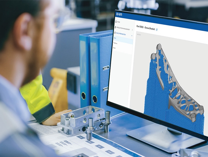 A man looking at a drone bracket design in the CO-AM software platform.