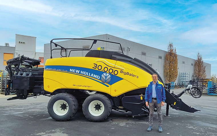 CNH employee with an agricultural baler machine, produced by CNH Industrial at their Zedelgem plant  