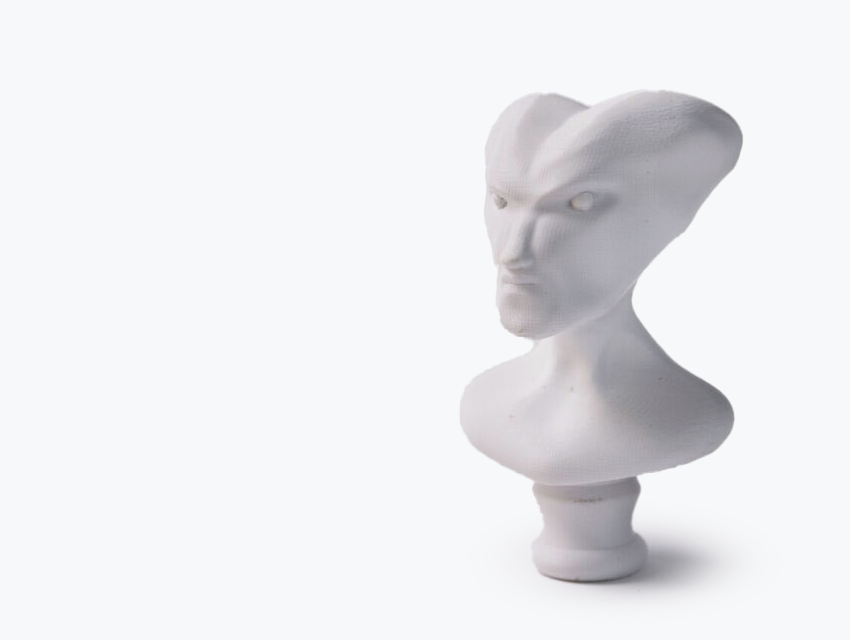 A white bust of an alien made in ABS using fused deposition modeling.