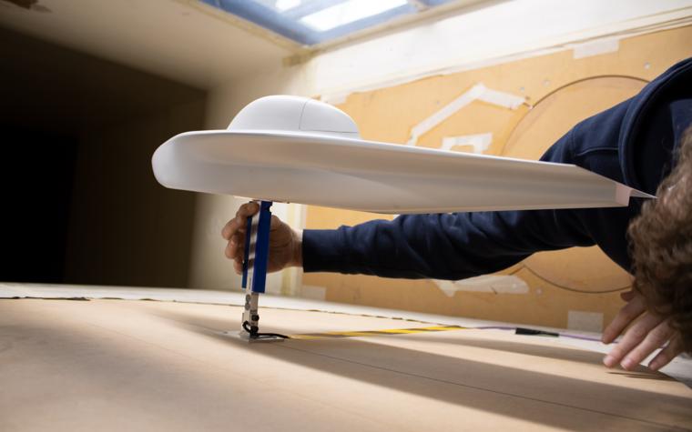 A white 3D-printed replica of the Agoria Solar Car is tested in a wind tunnel