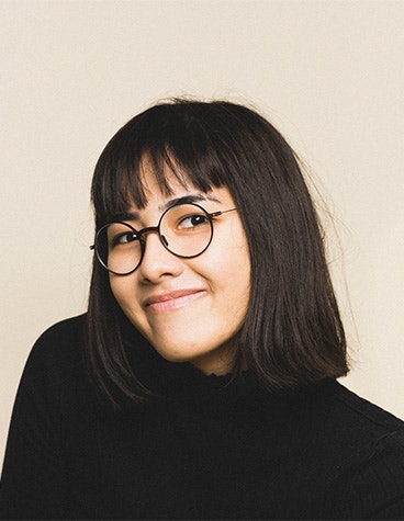 A woman smiling while wearing weareannu's 3D-printed Round 01 S eyewear frames