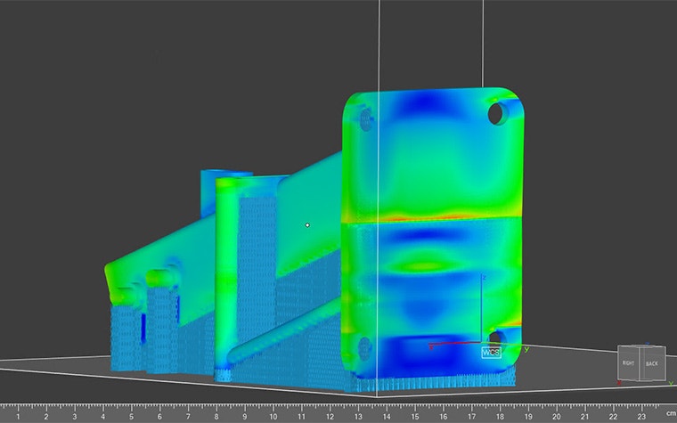 The heat signature of a 3D model being analyzed in the Ansys Simulation module. The model is a combination of green and blue while the supports are blue.