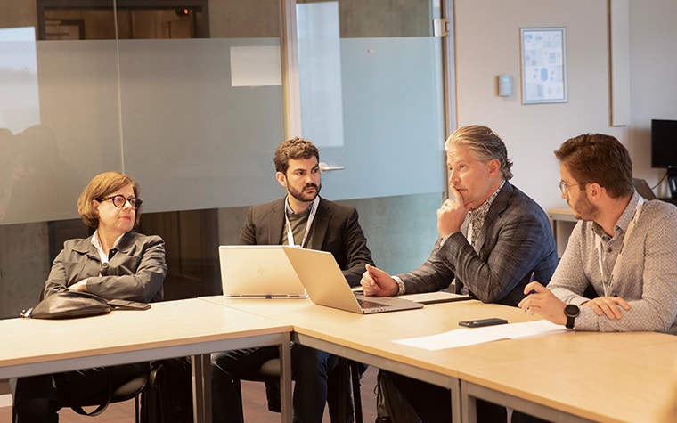 Four people having a discussion.