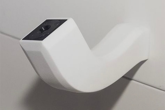 A curved 3D-printed component coming out of a wall