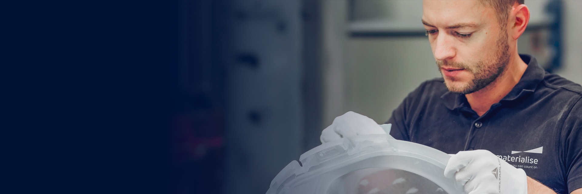 Man sanding a 3D-printed part in a Materialise production facility