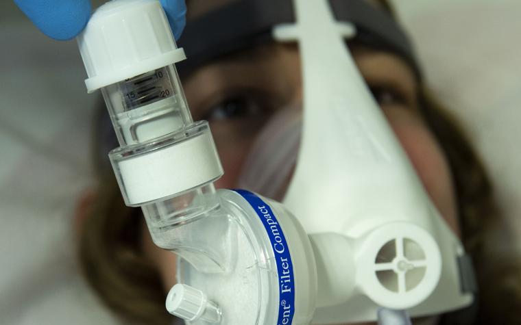 Patient wearing a non-invasive PEEP mask